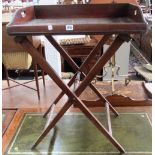 A George III mahogany butler's tray with pierced handles and folding 'X' frame stand, 67cm wide.