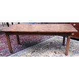 An early 19th century Continental pine plank top kitchen table, on square elm supports,