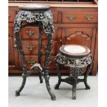 A late 19th century Chinese marble top carved hardwood urn stand, together with a similar smaller.