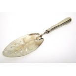 A silver fish slice, the oval pierced blade with engraved decoration, London 1800,