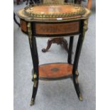 A 19th century French gilt metal mounted and ebonised amboyna oval two tier jardiniere on splayed