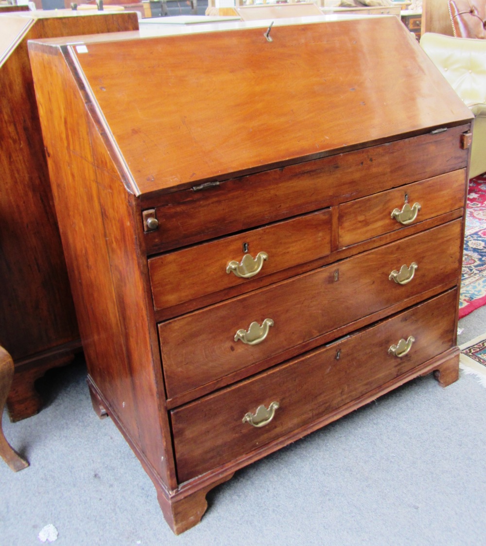 A George III fruitwood bureau, the fitted interior over two short and two long graduated drawers,