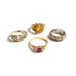 An 18ct gold ring, claw set with a rectangular cut ruby at the centre,