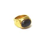 A gold ring mounted with an oval wood opal, detailed Cotter 14K, ring size M and a half,