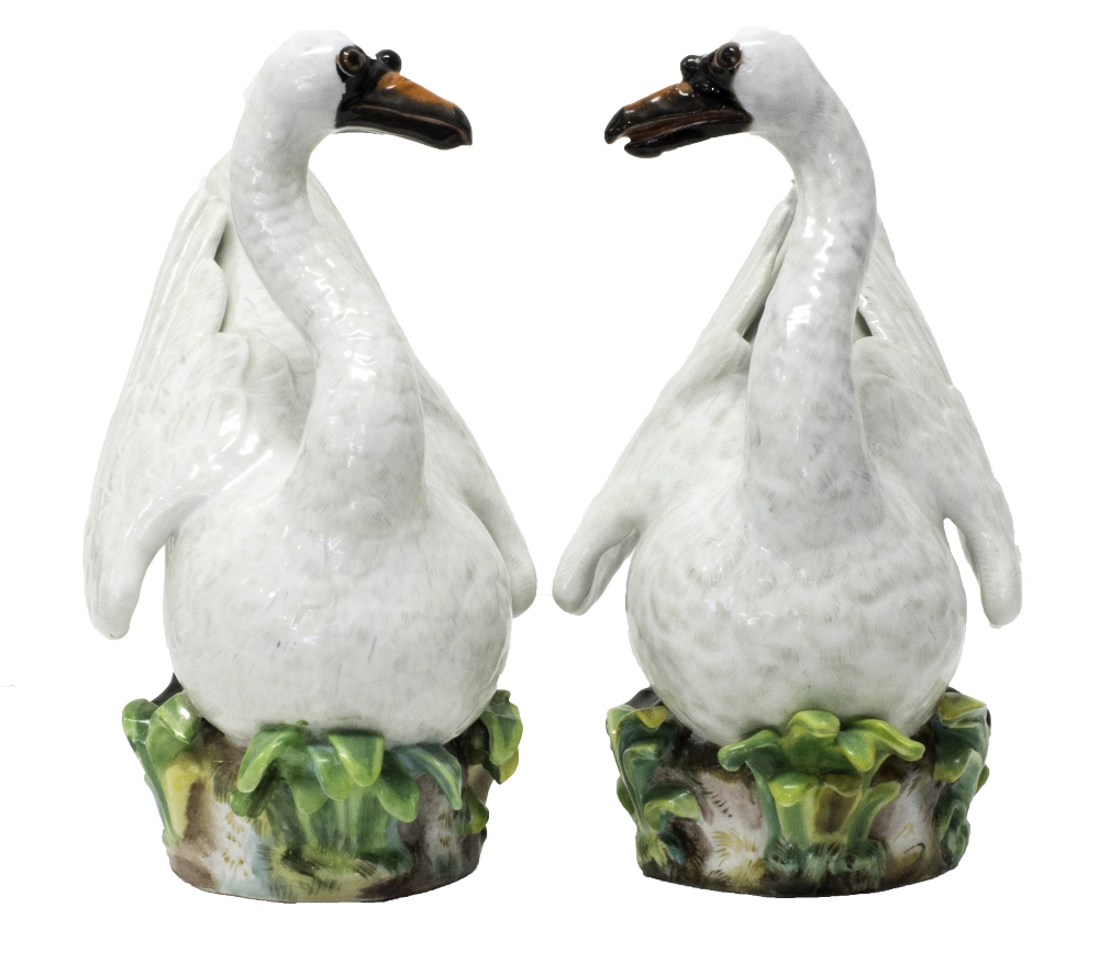 A pair of Meissen porcelain swans, late 19th century, modelled atop a naturalistic base,