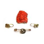 A gold mounted carved coral pendant brooch, carved as the portrait of a lady with flowing hair,