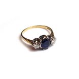 A gold, sapphire and diamond set three stone ring,