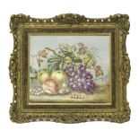 An English pottery plaque, late 19th century, painted with a still life of apples, grapes,