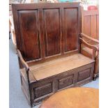 An 18th century and later oak high triple panel back open arm box settle, 110cm wide.