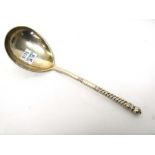 A Russian spoon, the fig shaped bowl engraved to the back with a
lady seated spinning,