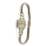 A lady's platinum cased and diamond set Omega dress wristwatch, with a signed jeweled movement,