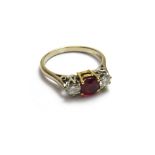 An 18ct white gold, ruby and diamond set three stone ring,