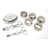 A silver oval tobacco box, Chester 1907, two pairs of scissor action sugar nips,