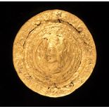 A Hellenistic style repoussé gold based alloy roundel,