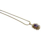 A gold mounted amethyst set single stone pendant, decorated with a pierced border,