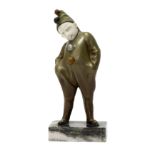 An Art Deco bronze and ivory figure, modelled and cast as a young boy in a clown's costume,