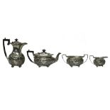 A silver four piece tea set, comprising; a teapot, a hot water jug,