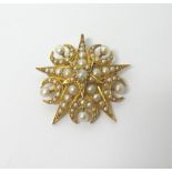 A gold and half pearl set pendant brooch, designed as a five pointed starburst,