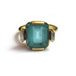 A gold, blue topaz and diamond set three stone ring,