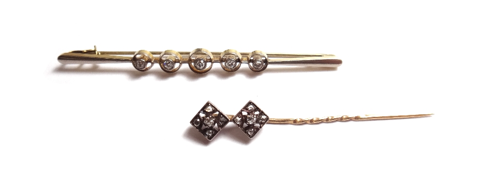 A gold and diamond set five stone bar brooch, collet set with a row of cushion shaped diamonds,
