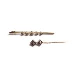 A gold and diamond set five stone bar brooch, collet set with a row of cushion shaped diamonds,