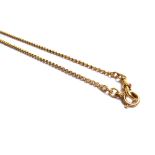 A gold long guard chain, in an oval and wirework link design,