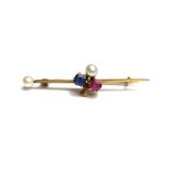 A gold, ruby, sapphire and cultured pearl set bar brooch, with a trefoil shaped motif at the centre,