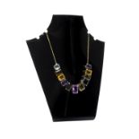 A gold and vary coloured gemstone set necklace,