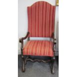 A pair of 18th century Continental oak framed high back open armchairs on scroll supports.