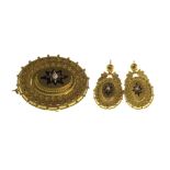 A Victorian gold, blue enamelled and half pearl set brooch and a matching pair of pendant earrings,