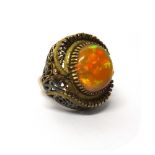 An opal set single stone dress ring,