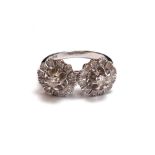 An 18ct white gold and diamond set ring, in a twin cluster design,