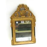 A small Louis XV style gilt framed wall mirror with pierced crest and rectangular mirror plate,