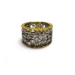 A yellow and white gold and diamond set band ring, in a pierced design,