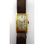 A gentleman's 9ct gold rectangular cased wristwatch, with a circular jeweled lever movement,