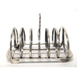 A William IV silver seven bar toastrack, with a loop shaped handle, raised on four feet,