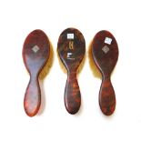 An Edwardian tortoiseshell part dressing table set with paste set applied initials 'MM',