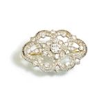 A diamond brooch, in a shaped hexagonal pierced openwork design,