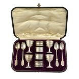 A Victorian silver egg cup and spoon set, comprising; four egg cups,