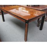 An Art Deco yew rectangular extending dining table on ebonised block supports,
