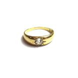 A gold and diamond set single stone ring, gypsy set with a cushion shaped diamond, detailed 8.8.