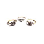 An 18ct gold and diamond set three stone ring, mounted with circular cut diamonds,