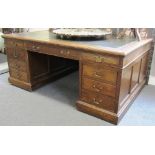 An 18th century style oak partners desk with nine drawers about the knee and pedestal cupboards