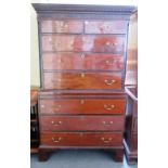 A George III mahogany chest on chest with two short over two long graduated drawers divided by