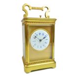 An Edwardian gilt brass cased carriage clock,