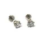 A pair of diamond set single stone earstuds, each claw set with a circular cut diamond,