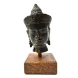 A small Khmer bronze head of buddha,Angkor Wat style,  probably 13th century,