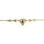 A gold, garnet and seed pearl set necklace, the front in a pierced scrolling and foliate design,