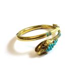 A Victorian gold and turquoise set sprung hinged bangle, designed as a coiled snake,