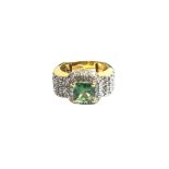 A 14ct gold, diamond and green gemstone set dress ring,